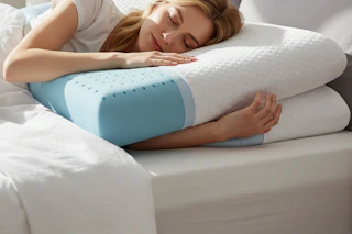 a woman laying memory foam pillows