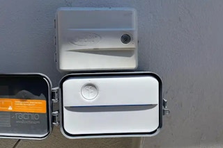 costco rachio 3 smart sprinkler controller mounted on a wall