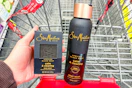 person holding a sheamoisture bar soap next to a body wash in a cart