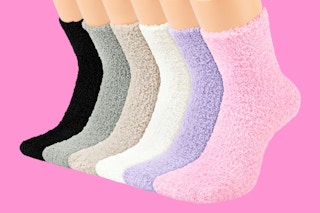 6 pairs of Women's fuzzy socks in different colors over pink background