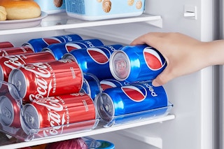 Cans of soda in clear organizers in a fridge