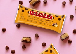Larabars on a pink surface next to chocolate chips