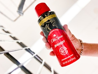 worm's eye view from shopping cart of a hand placing can of deodorant spray in cart