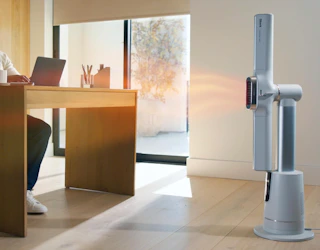 a fan in front of a person's work desk