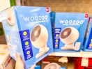 hand holding a woozoo fan in front of a target shelf