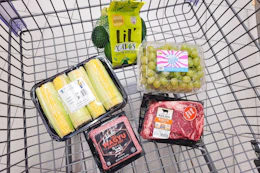 corn, avocadoes, wagyu beef, ribeye steak, and cotton candy grapes in a cart