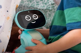 a kid holding a blue AI robot