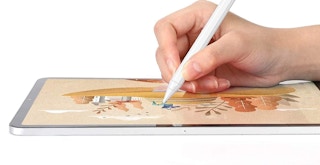 A hand writing with a stylus pen on an iPad