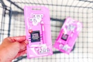person putting a pack of disposable razors in a cart with another pack in it