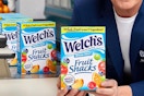 someone holding Welch's fruit snacks box