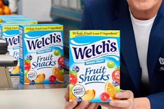someone holding Welch's fruit snacks box