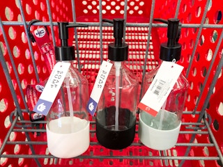 three glass soap bottles in Target shopping cart