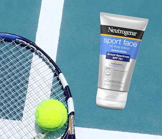 a tube of sunscreen on the ground next to a racket and tennis ball
