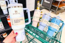 a person holding up a stanley cup at dicks sporting goods