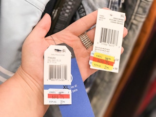 someone holding two price tags