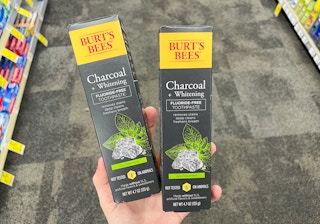 hand holding two burt's bees toothpastes