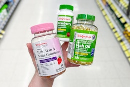 hand holding walgreens vitamins