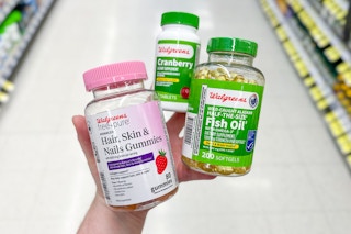 hand holding walgreens vitamins