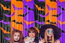 kids in front of a halloween backdrop