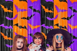 kids in front of a halloween backdrop