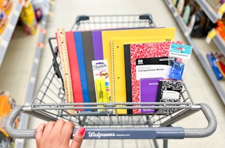 hand holding cart with Wexford Pocket folders, ruler, pencil sharpener, memo pad, notebook, composition book, and mini composition book ...