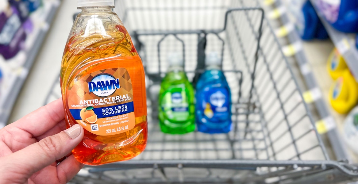 a hand holding up dawn dish soap in a walgreens