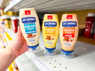 hand holding a bottle of hellman's chicken tender dip next to two others on meijer shelf