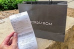 Nordstrom receipt held up in front of bag
