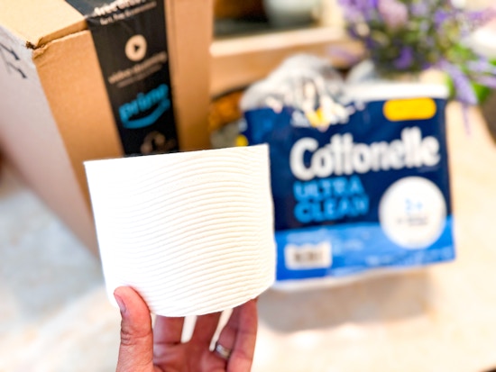 Cottonelle toilet paper being held in front of prime box