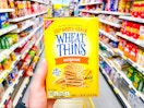 hand holding a box of wheat thins crackers