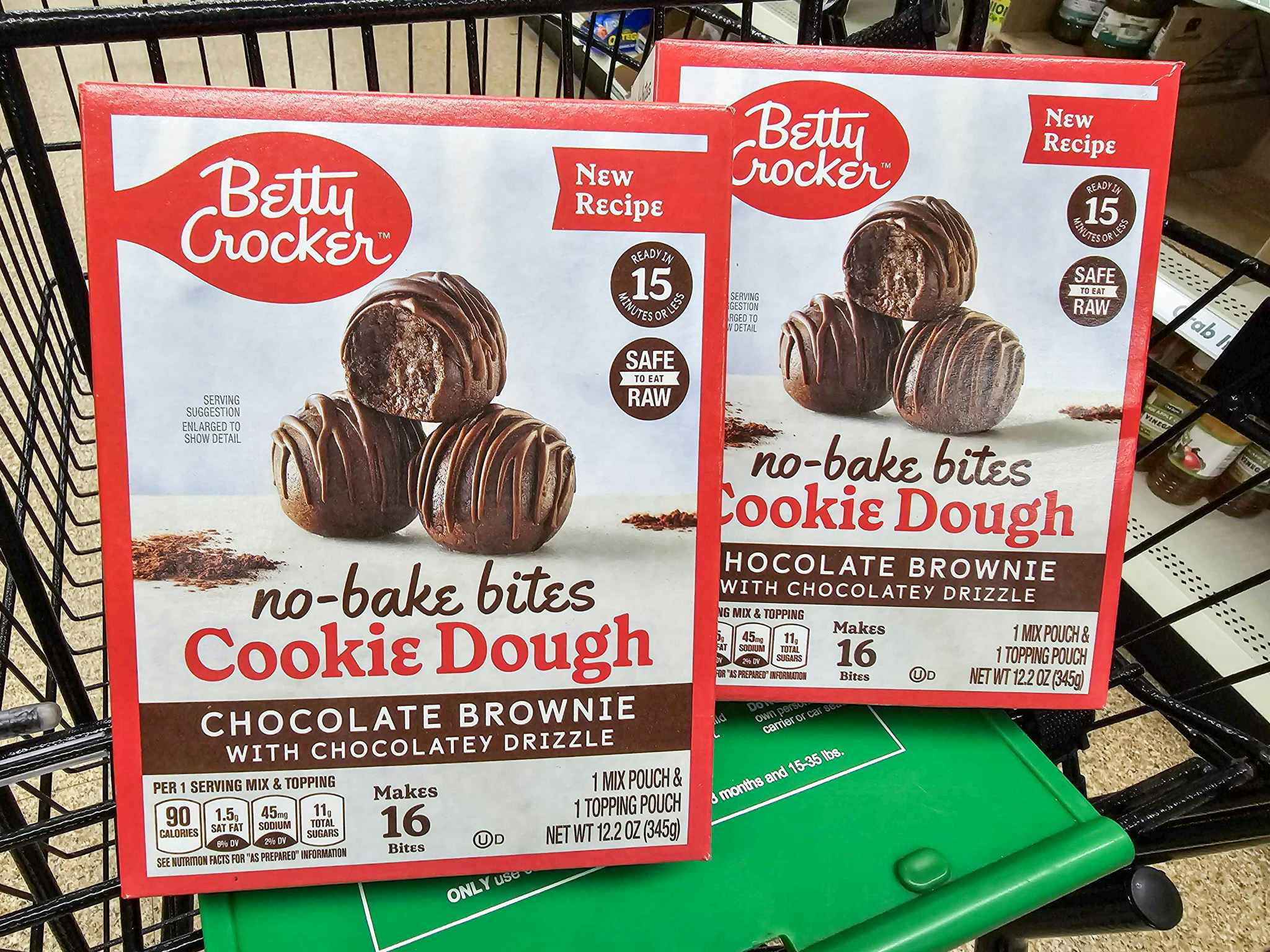 2 boxes of betty crocker no bake cookie dough bites in a cart