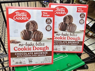 2 boxes of betty crocker no bake cookie dough bites in a cart