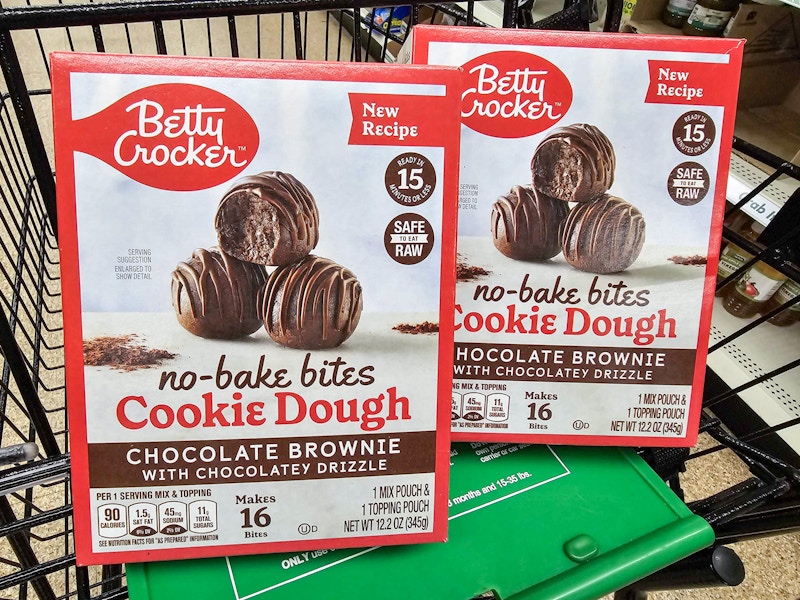 2 boxes of betty crocker no bake cookie dough bites in a cart