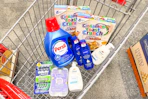 gillette and venus razors, dove hand wash, persil detergent, nivea lotion, and cinnamon toast crunch cereal in a cart