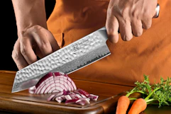 person chopping onion with knife
