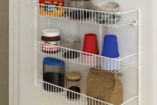 a white metal rack full of food on a door