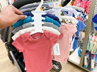 5 pack of carters bodysuits held next to a rack of other body suits in kohls