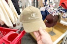 hand holding a champion hat in front of hats on target shelves