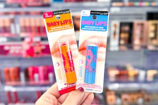 hand holding two Maybelline Baby Lips