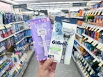 hand holding gillette and venus razors in walgreens