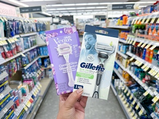 hand holding gillette and venus razors in walgreens