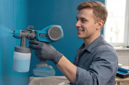 a man using a paint sprayer