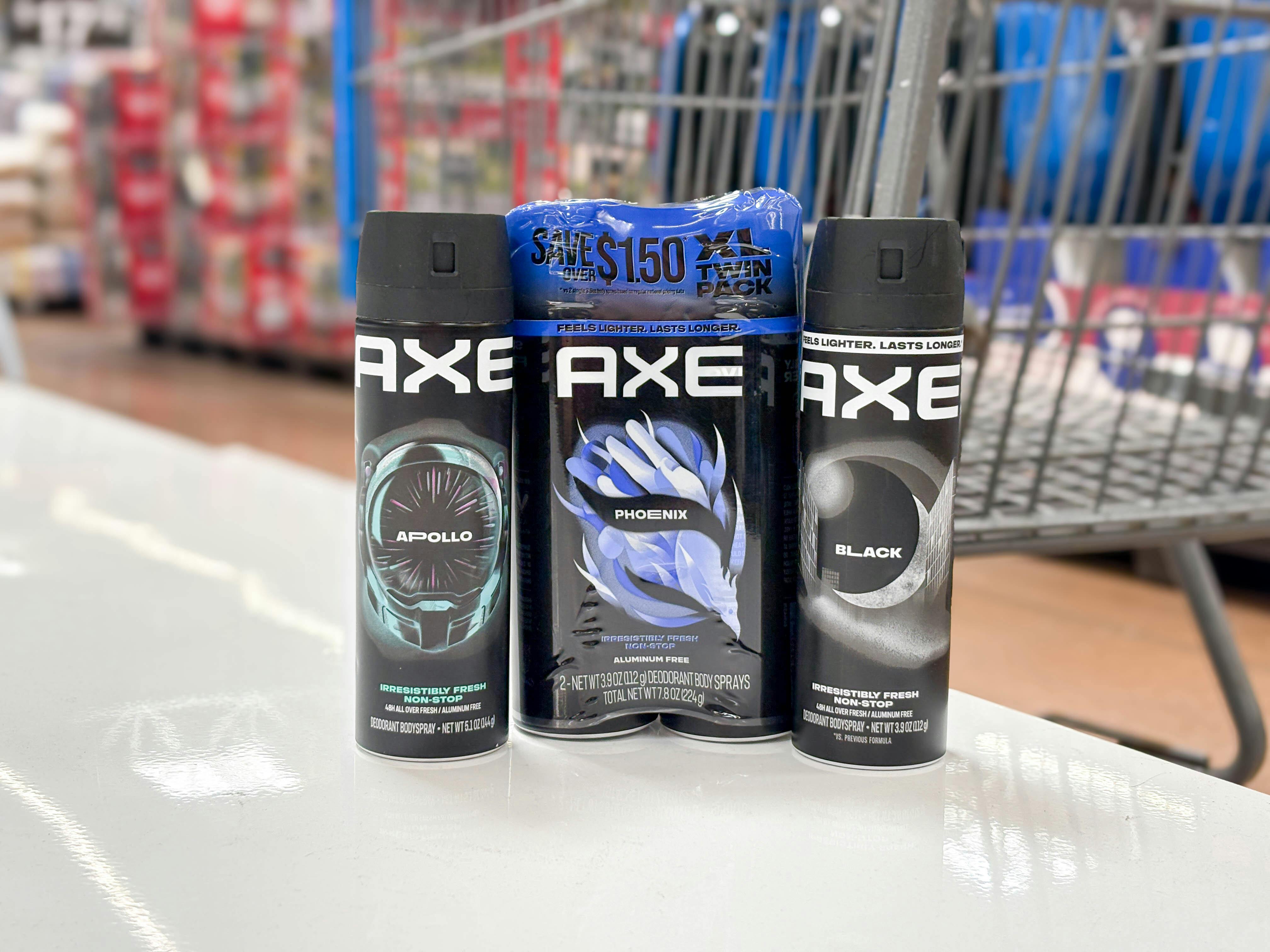 3 axe body sprays together in front a walmart cart