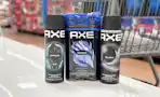 3 axe body sprays together in front a walmart cart