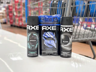 3 axe body sprays together in front a walmart cart