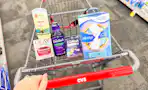 person pushing a cart with old spice deodorant, olay moisturizer, zzzquil products, and always pads