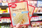 hand holding up betty crocker cake mix