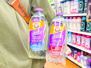 hand holding bottles of arm hammer fabric rinse
