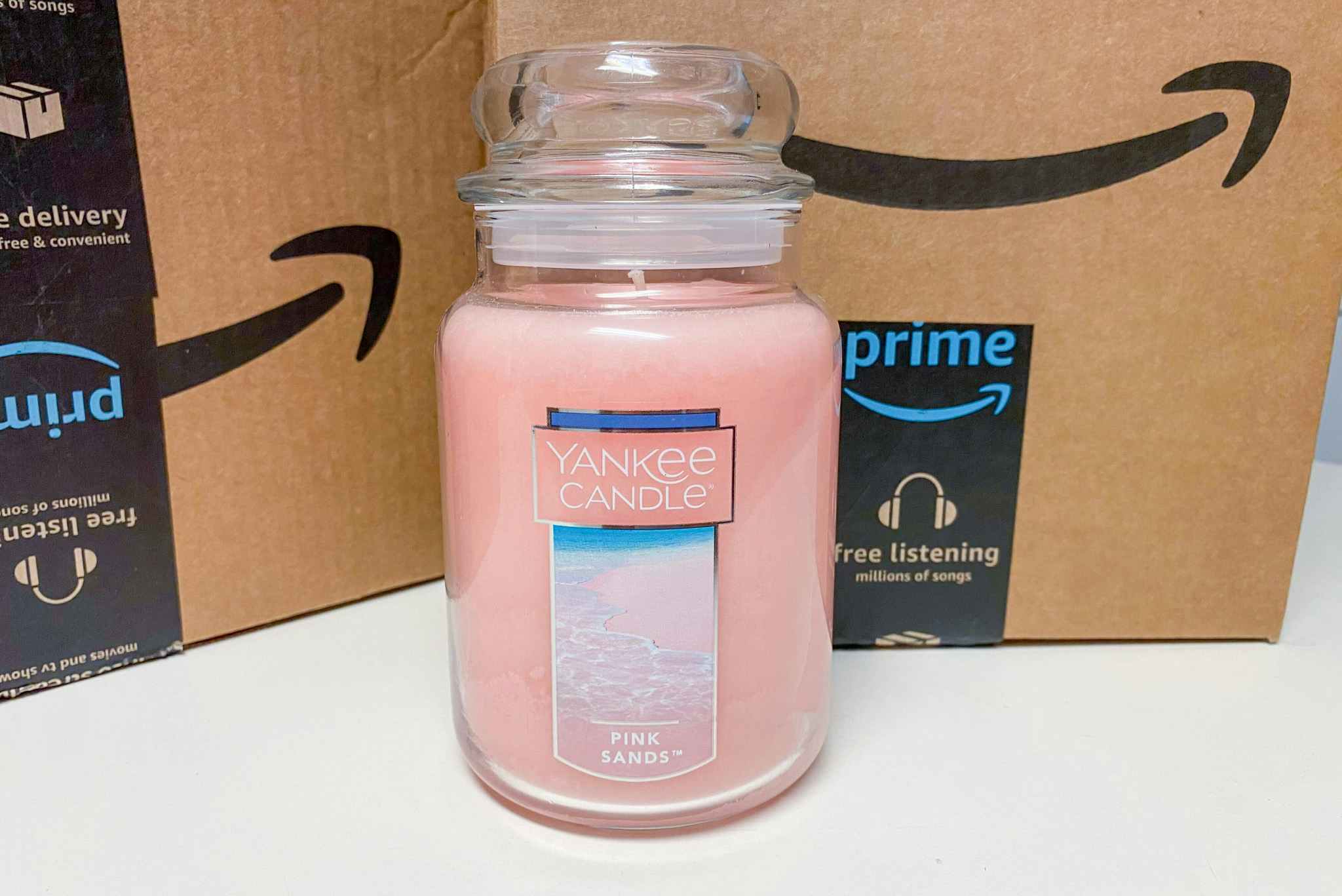 a yankee candle in front of some amazon boxes