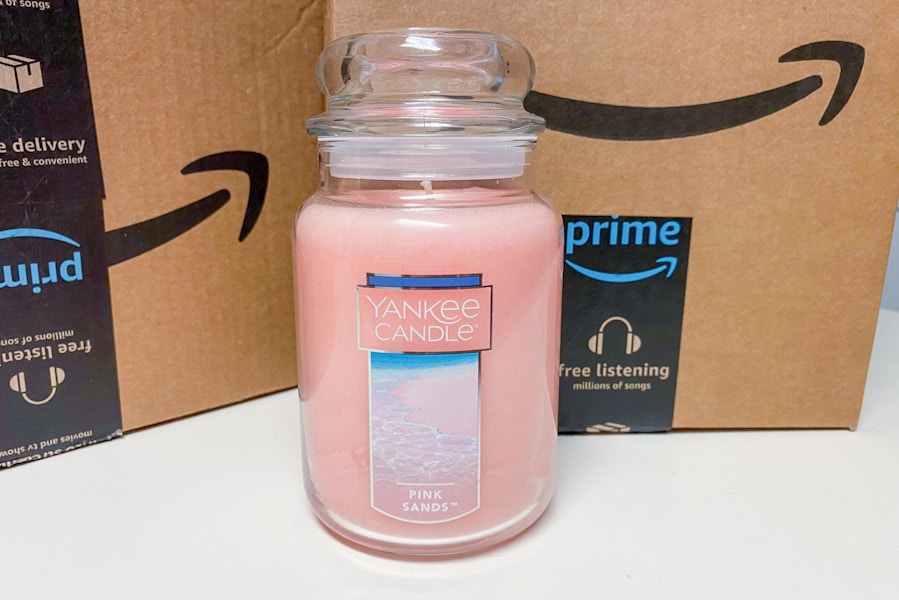 a yankee candle in front of some amazon boxes